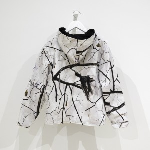 cotton duck cloth vest made of camouflage fabric showing winter branches with plastic bags stuck in them