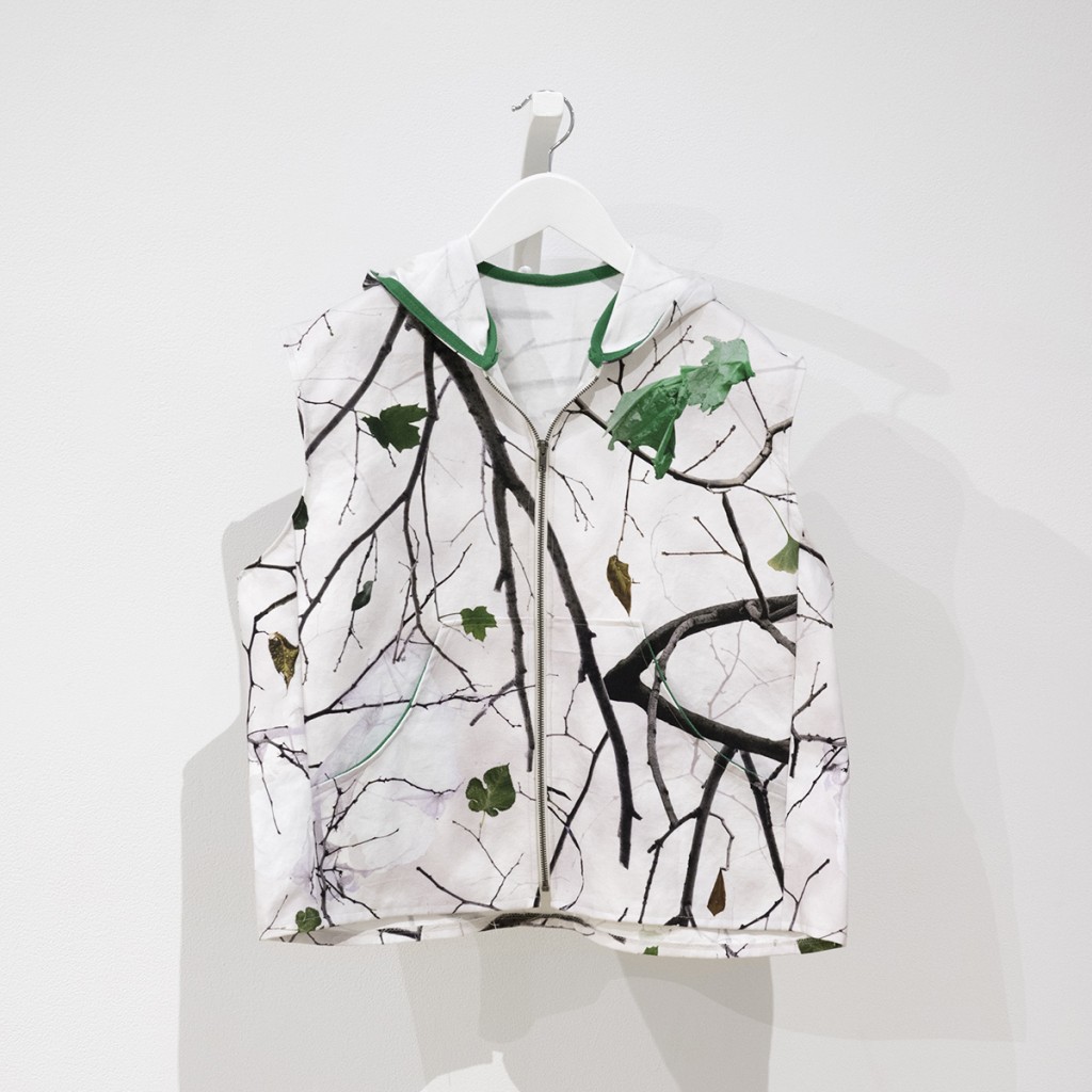 cotton duck cloth vest made of camouflage fabric showing winter branches with plastic bags stuck in them