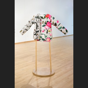 Reversible jacket with one side showing summer floral pattern of bright pink roses and the other side showing a winter version of those same plants, made by Stephanie Lynn Rogers