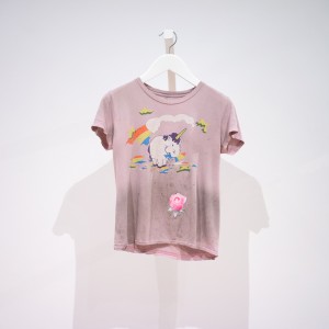 pale pink shirt with a unicorn eating a rainbow and a rose bud patch