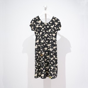 dress with daisies on a field of black with white polka dots, mended with insect patches