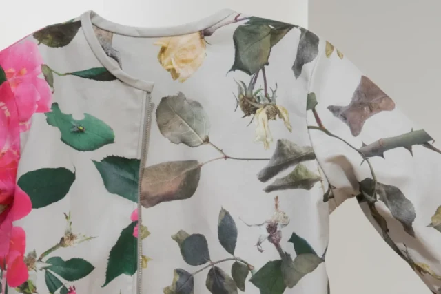 Detail of Seasonal Shift, a reversible coat with custom-made photographic repeat patterns showing roses in summer and in winter.