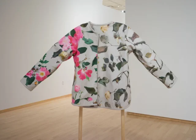 Seasonal Shift, a reversible coat with custom-made photographic repeat patterns showing roses in summer and in winter.