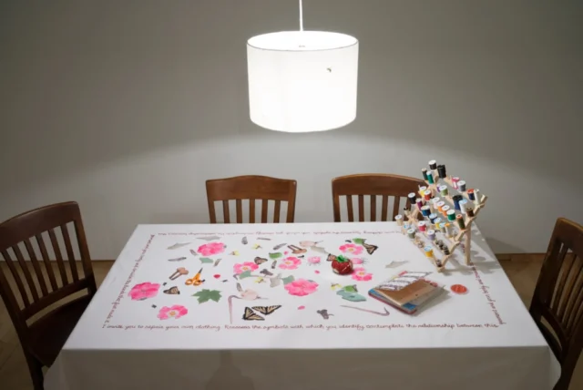 Set-up of a table with custom-made fabric patches set-up on a work table with materials for visible mending
