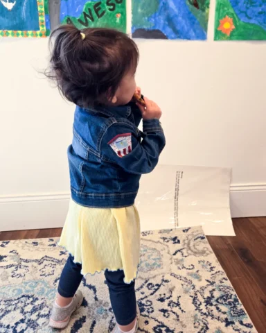 Amendments_20240413_101305 young child wears a denim jacket with a small fabric patch showing a popcorn stand on the sleeve