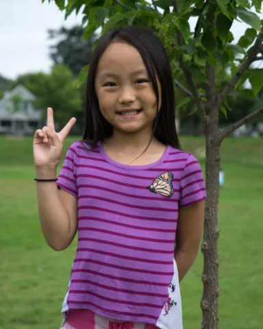 Amendments_DSC00966 copy a young girl shows off her shirt with a monarch butterly patch