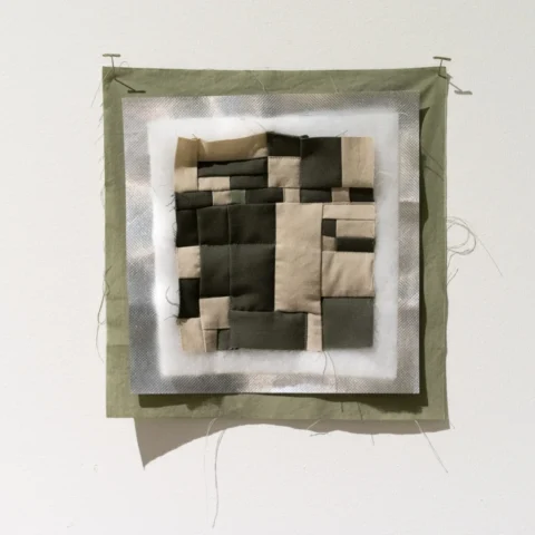 Security_Blanket_DSC00032 A close-up sampler showing the layers of a quilt: a green backing, a shiny silver thermal reflective layer, white batting, and the pieced top which is a digital camouflage pattern.